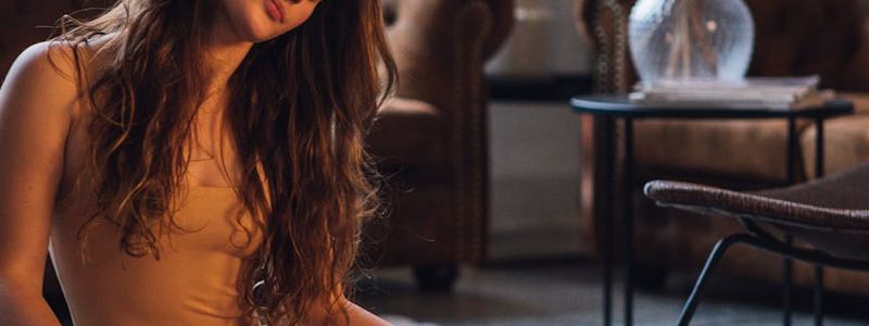 A person performing a gentle stretch on a yoga mat.